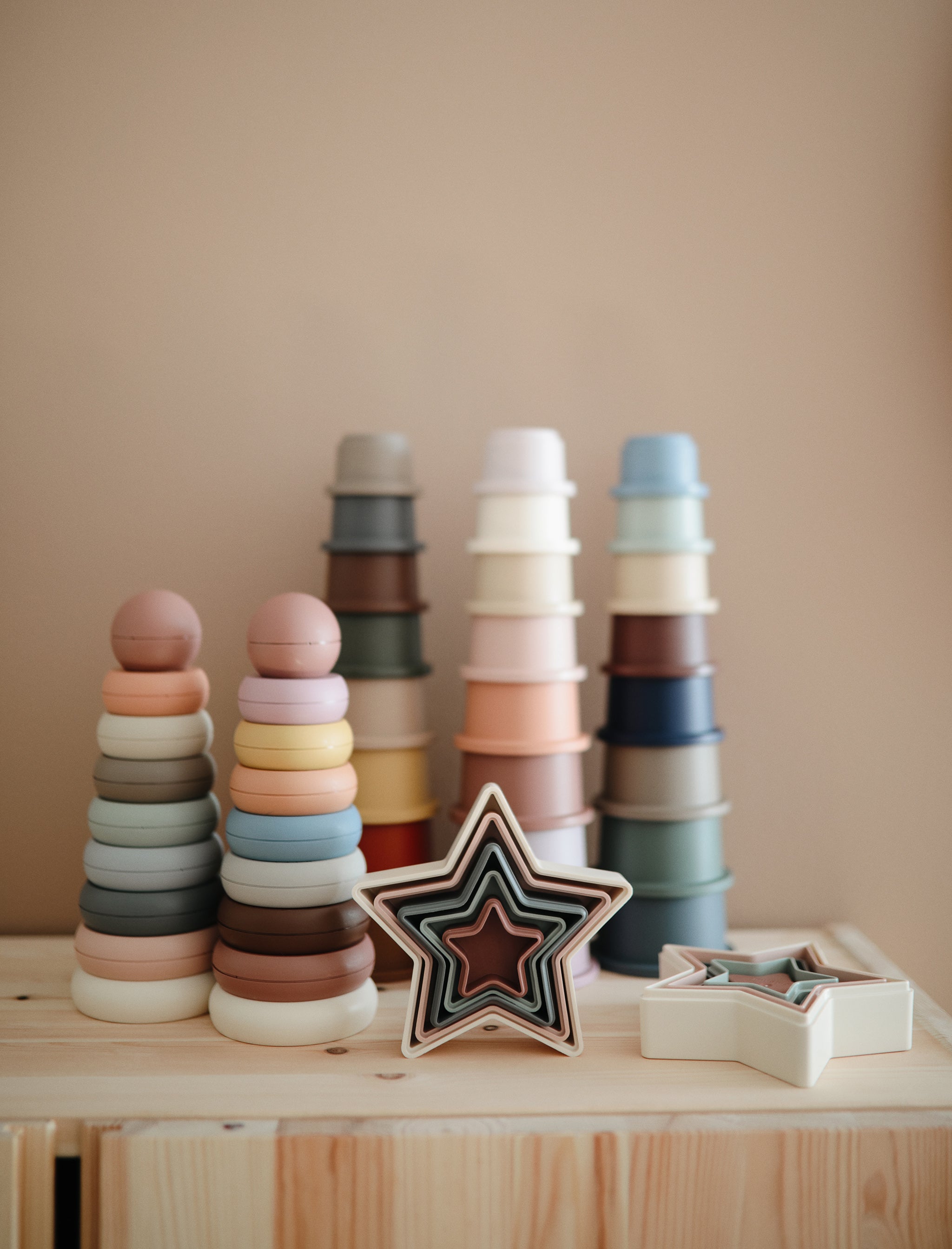 Mushie silicone stacking cups in soft neutral colors for toddler play