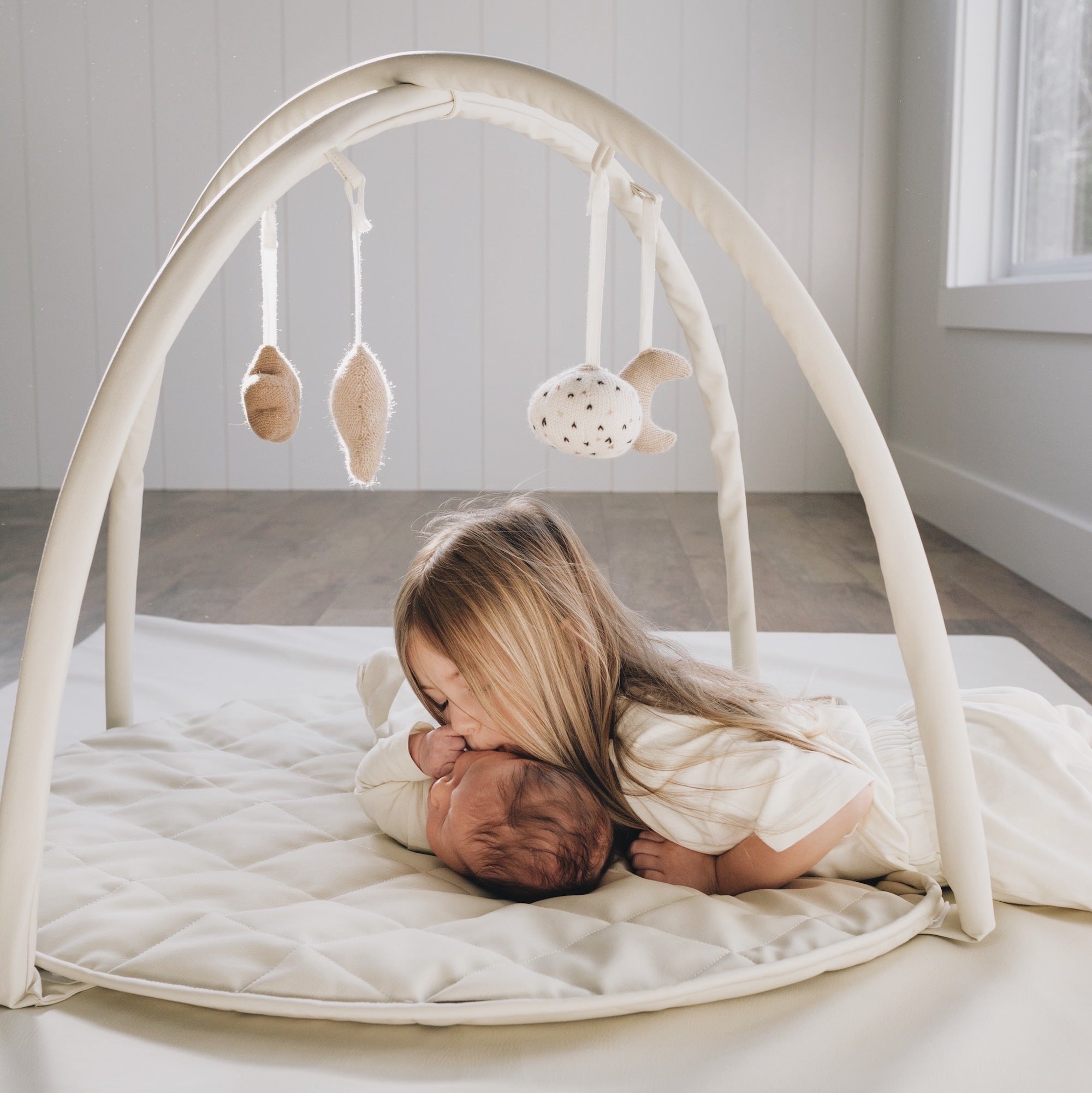 Gathre baby activity gym with leather mat base and wooden arch