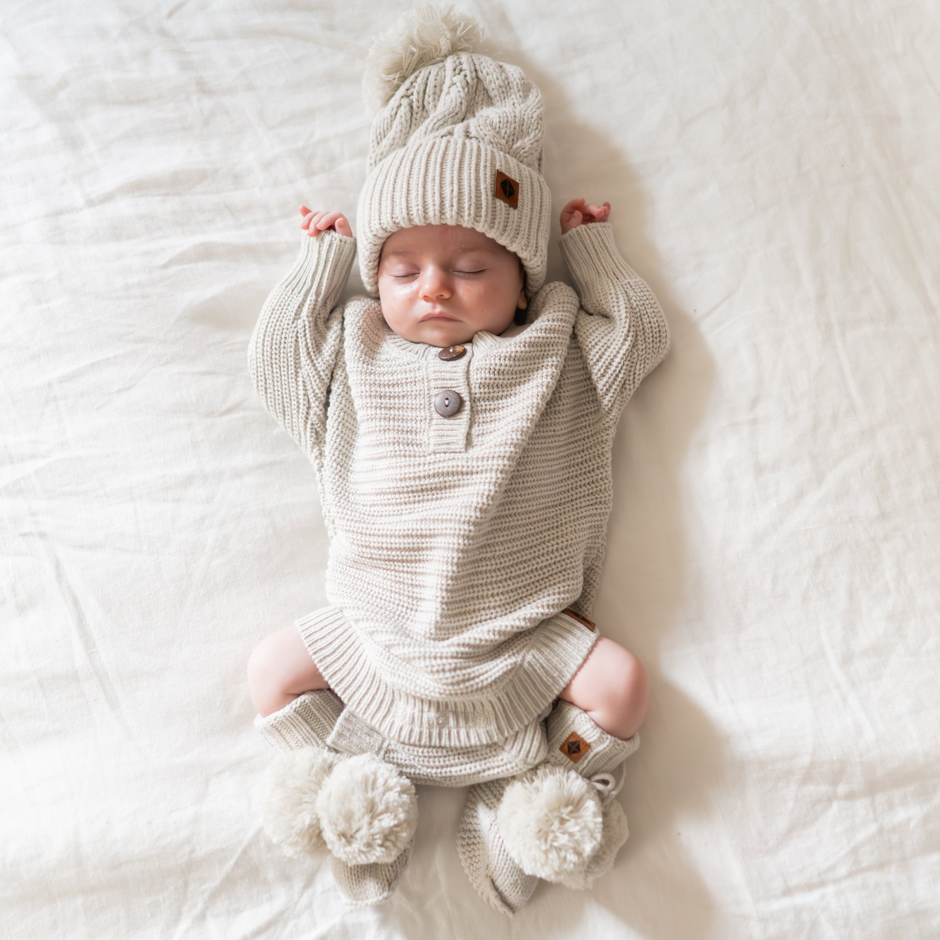 Kyte Baby chunky knit romper in oat neutral color for newborn