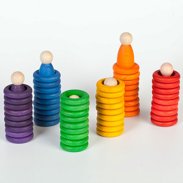 Grapat wooden mandala nins rings and coins in muted earthy colors arranged on a surface